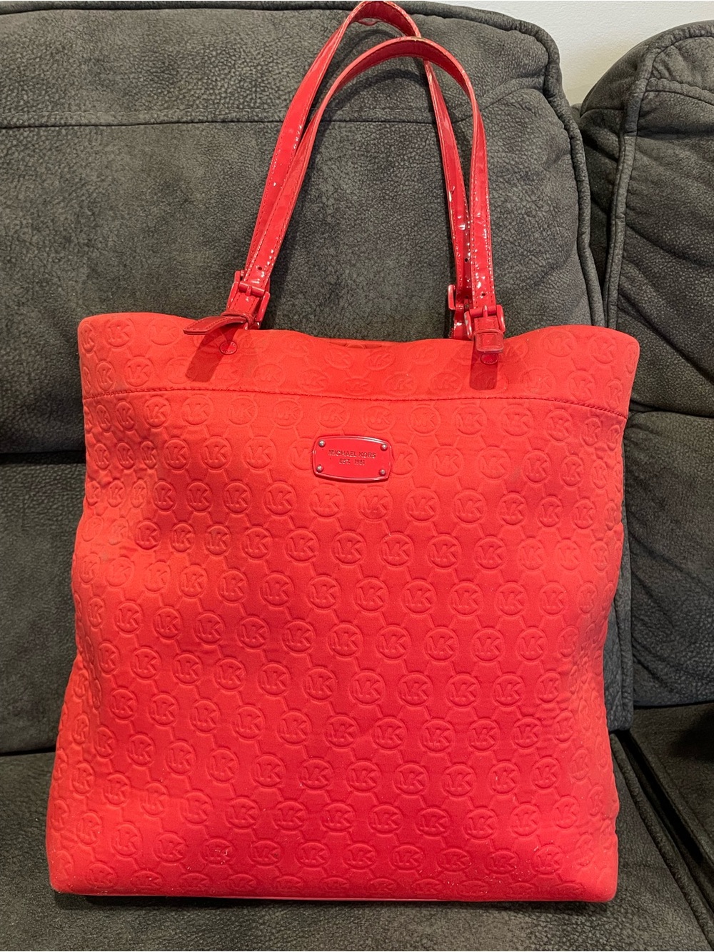 Michael Kors Bright Coral color, Embossed MK Tote or book bag.